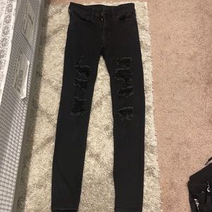 Size 0 American Eagle skinny ripped black jeans. No damage or stains.